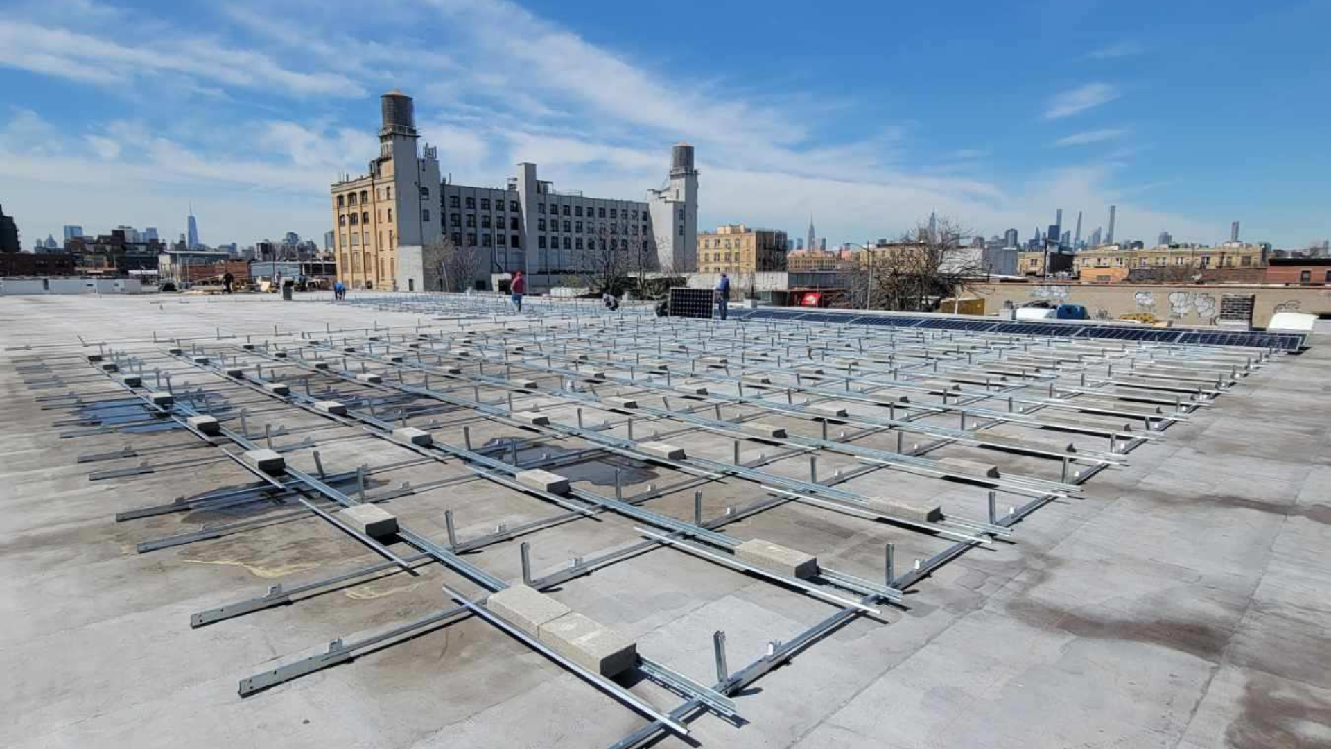 Kamtech Solar before image showing a commercial rooftop with mounting racks installed in preparation for solar panels.