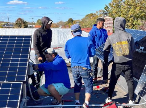 Kamtech Solar installation crew setting up rooftop solar panels in New Jersey, showcasing expert solar energy installation and teamwork for clean power solutions.