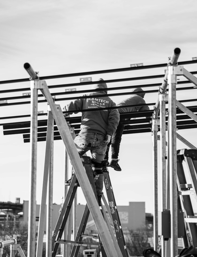 Kamtech Solar technicians installing a solar racking system on-site, demonstrating expert craftsmanship and precision in solar construction. Kamtech Solar technicians installing a solar racking system on-site, demonstrating expert craftsmanship and precision in solar construction.
