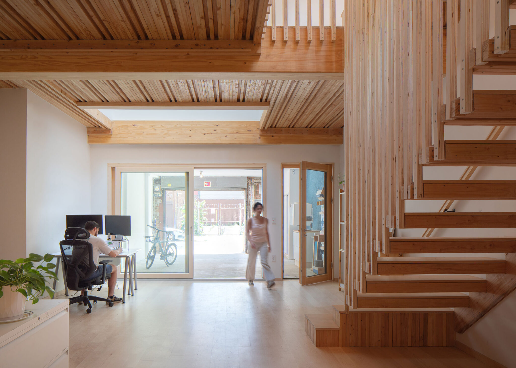 Ground floor office and showroom interior at 475 High Performance Building Supply, Brooklyn NY — exposed nail-laminated timber structure and Passive House certified envelope